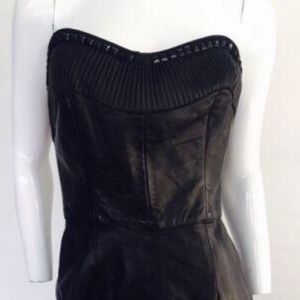 Black leather  strapless dress. 

Features a sweetheart plunge cleavage.